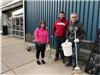 Three Volunteers Holding a Broom and Bucket