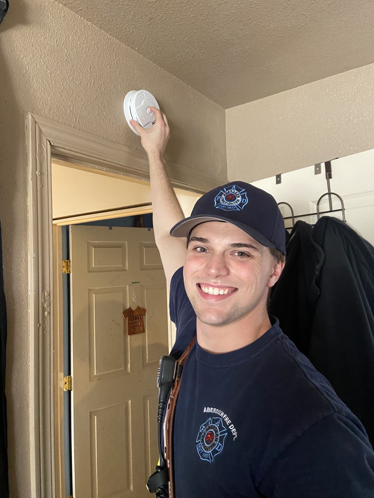 Aberdeen Fireifghter Checking a Smoke Alarm